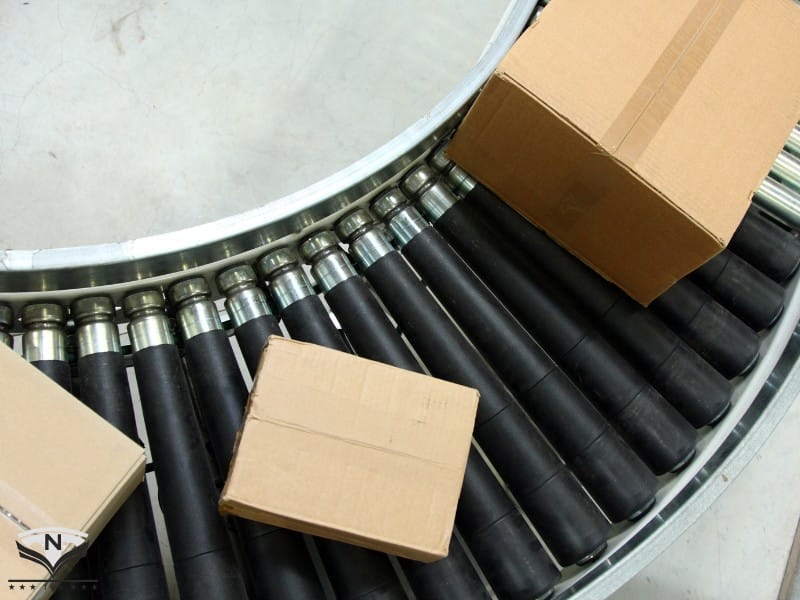 Dây chuyền vận chuyển thùng hàng carton tự động với băng tải góc cong